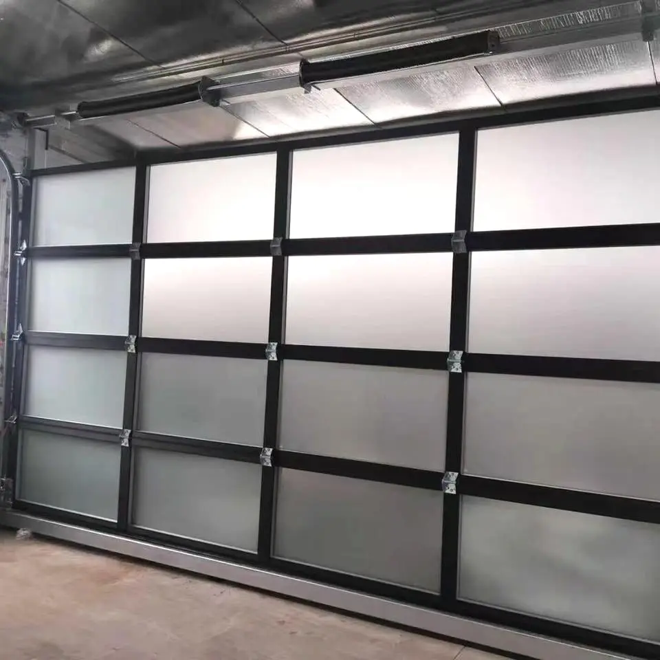 A newly fitted full-view door with black aluminium framing and frosted glass panels