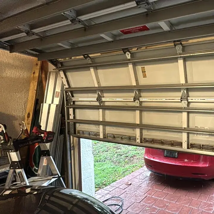 Cable drums, roller stems and packaged hardware laid out among the springs in the truck bed