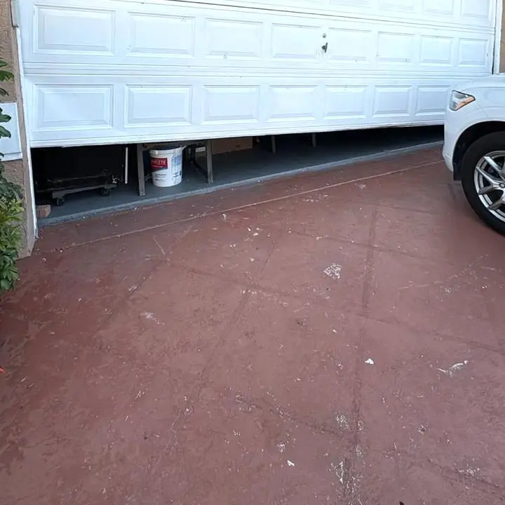 The lower half of a white sectional door showing the bottom seal and the panel above it