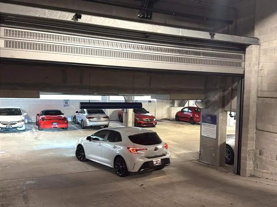 A steel roll-up door on a commercial parking structure, seen from the apron