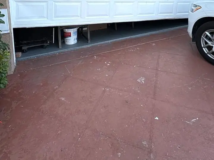 A white sectional garage door above a brick driveway